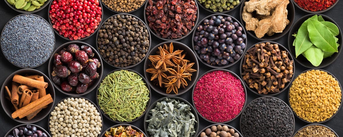 Fresh spices and herbs for food. Colorful condiments as background, top view. lot seasonings in cups, on table